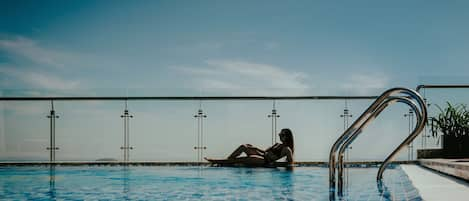 Outdoor pool, an infinity pool, open 6:00 AM to 8:00 PM, pool umbrellas