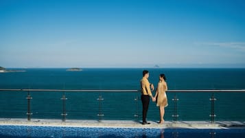Outdoor pool, an infinity pool, open 6:00 AM to 8:00 PM, pool umbrellas
