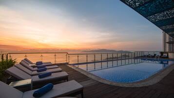 Outdoor pool, an infinity pool, open 6:00 AM to 8:00 PM, pool umbrellas