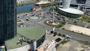 A modern urban area with high-rise buildings, a roundabout, and a view of the sea. - Orbi city Davide (Batumi)