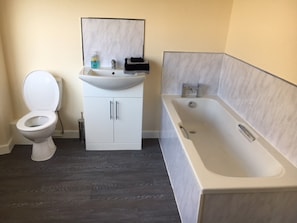 A bathroom with a toilet, a sink, and a bathtub.