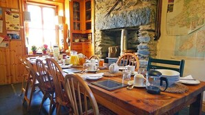 Ein Holzespeisesaal mit Frühstücksgebäck, umgeben von Holzstühlen.