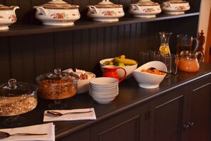 A buffet setup with various dishes and serving ware. - Cape Dutch at Keerweder (Franschhoek)