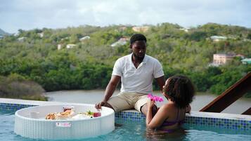 Relax by the serene pool, surrounded by a lush hillside view.