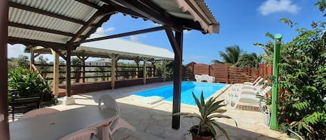 Piscine extérieure, parasols de plage, chaises longues