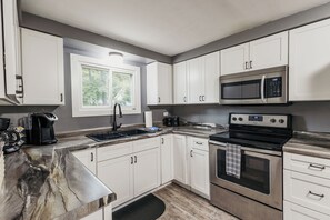 Fridge, microwave, oven, stovetop - Spacious & Updated! Marquette Township Home - HotTub - Backyard - Garage (Marquette)