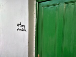 A green door with the name "Nelson Mandela" written on a white wall to the left. - I Miti Vivienda Vacacional (Guia de Isora)
