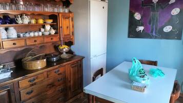 Full-sized fridge, microwave, stovetop, cookware/dishes/utensils