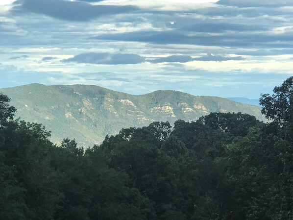 A mountainous landscape with dense forest in the foreground and rocky hills in the background. - Entire Guest Suite in Haus Edelweiss on the Blue Ridge Parkway (Marion)
