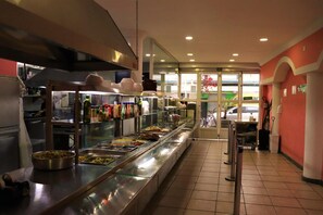 A buffet setup with various food items and condiments. - Ibéricas Praia Hotel (Praia Grande)