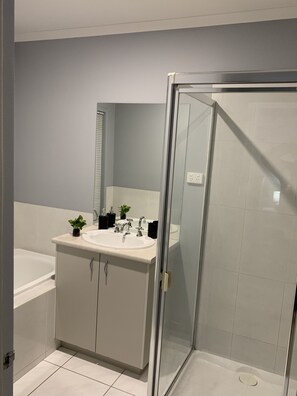 Shower, hair dryer, towels, shampoo