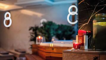 A cozy room with a wooden cabinet, a glass container, and candles on a table.