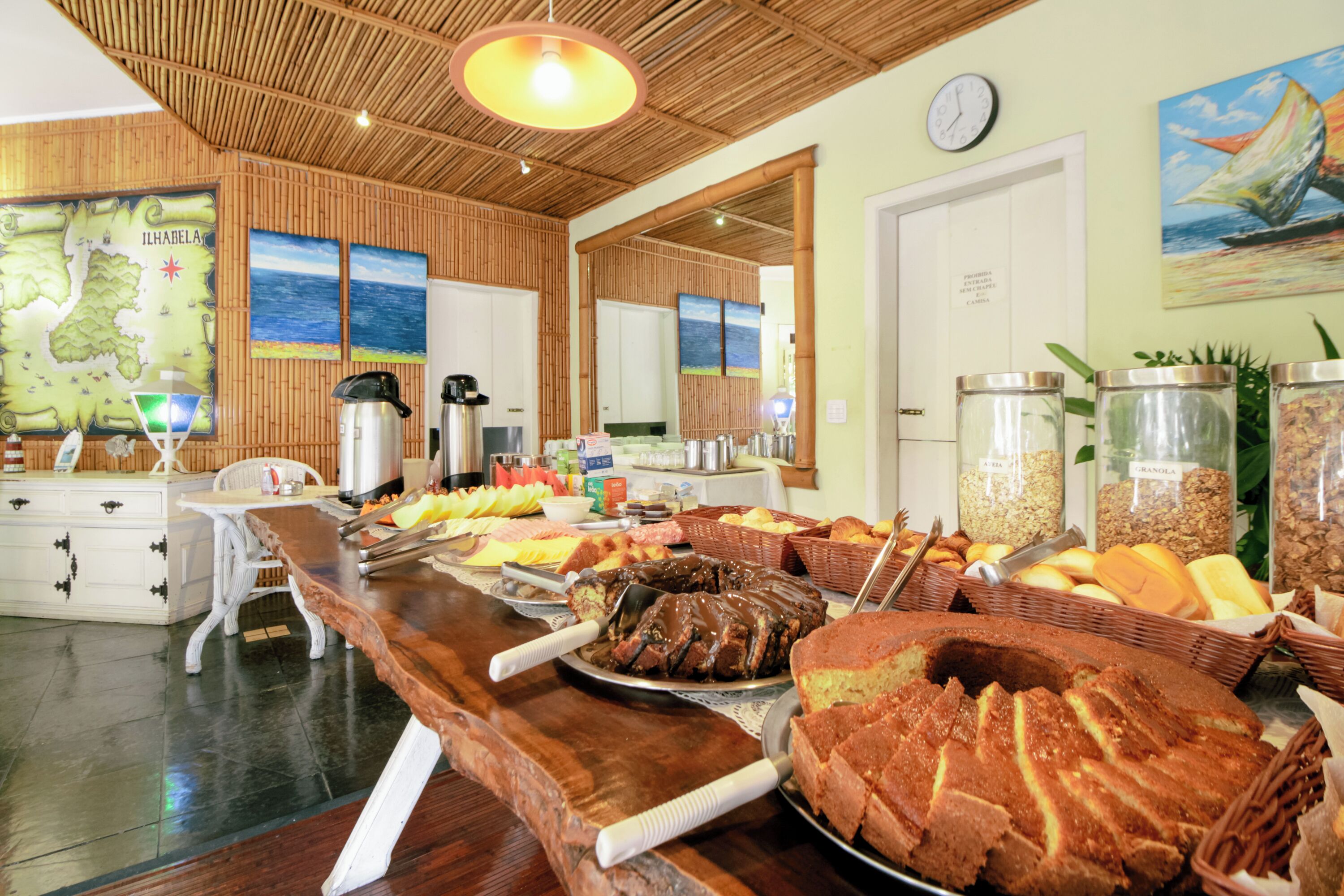 A buffet with various food items, a wooden ceiling, and a map on the wall.