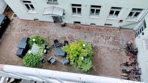 An aerial view of a courtyard with a seating area, greenery, and bicycles. - Helsinki city centre studio & loft (Helsinki)