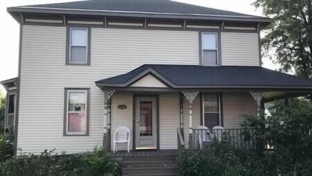A two-story house with a front porch, a small front yard, and a visible mailbox. - Charming home in the heart of Rockland, Charming home in the heart of Rockland (Rockland)