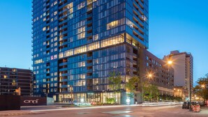 A high-rise building with multiple floors, large windows, and a modern architectural design.