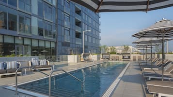 Seasonal outdoor pool, open 7:00 AM to 10:00 PM, pool umbrellas