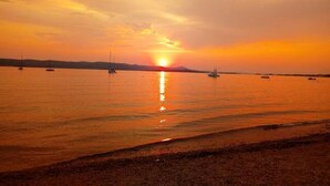 A sunset over a calm body of water with boats. - Comfortable one bedroom apartment 2+1
max. for 3 persons (Biograd n/m)