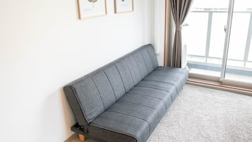 Quarto família (Deluxe) | Sala de estar | TV de tela plana