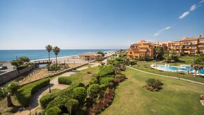 A resort with a pool, beach, and ocean view.