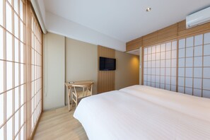 A hotel room with a bed, a desk, a TV, and a sliding shoji screen. - 9 Hotel Hakata (Fukuoka)