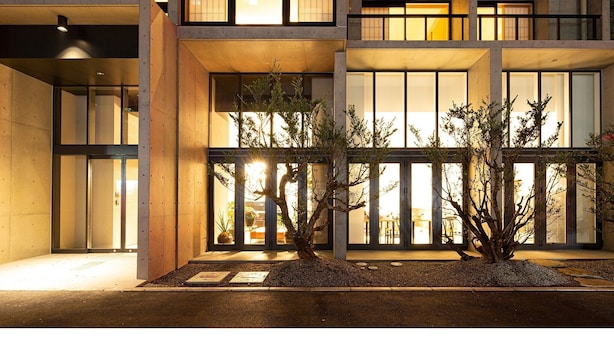 A modern building with large windows and a well-lit entrance. - 9 Hotel Hakata (Fukuoka)