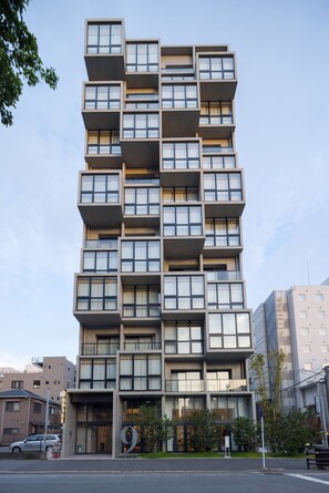 A modern multi-story hotel with a unique modular design, featuring balconies and large windows. - 9 Hotel Hakata (Fukuoka)