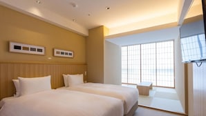 A hotel room with two beds, a large window, and a sliding door leading to a balcony. - 9 Hotel Hakata (Fukuoka)