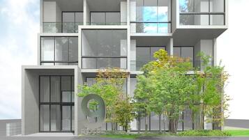 A modern multi-story building with large windows and a prominent circular design element on the facade.