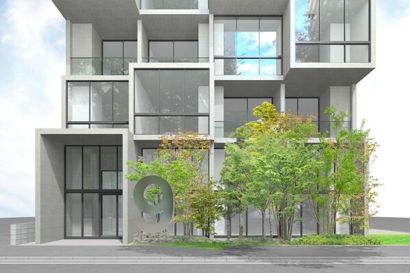 A modern multi-story building with large windows and a prominent circular design element on the facade.