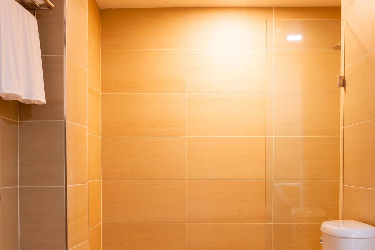 suite triple room | bathroom | shower, rainfall showerhead, hair dryer, towels