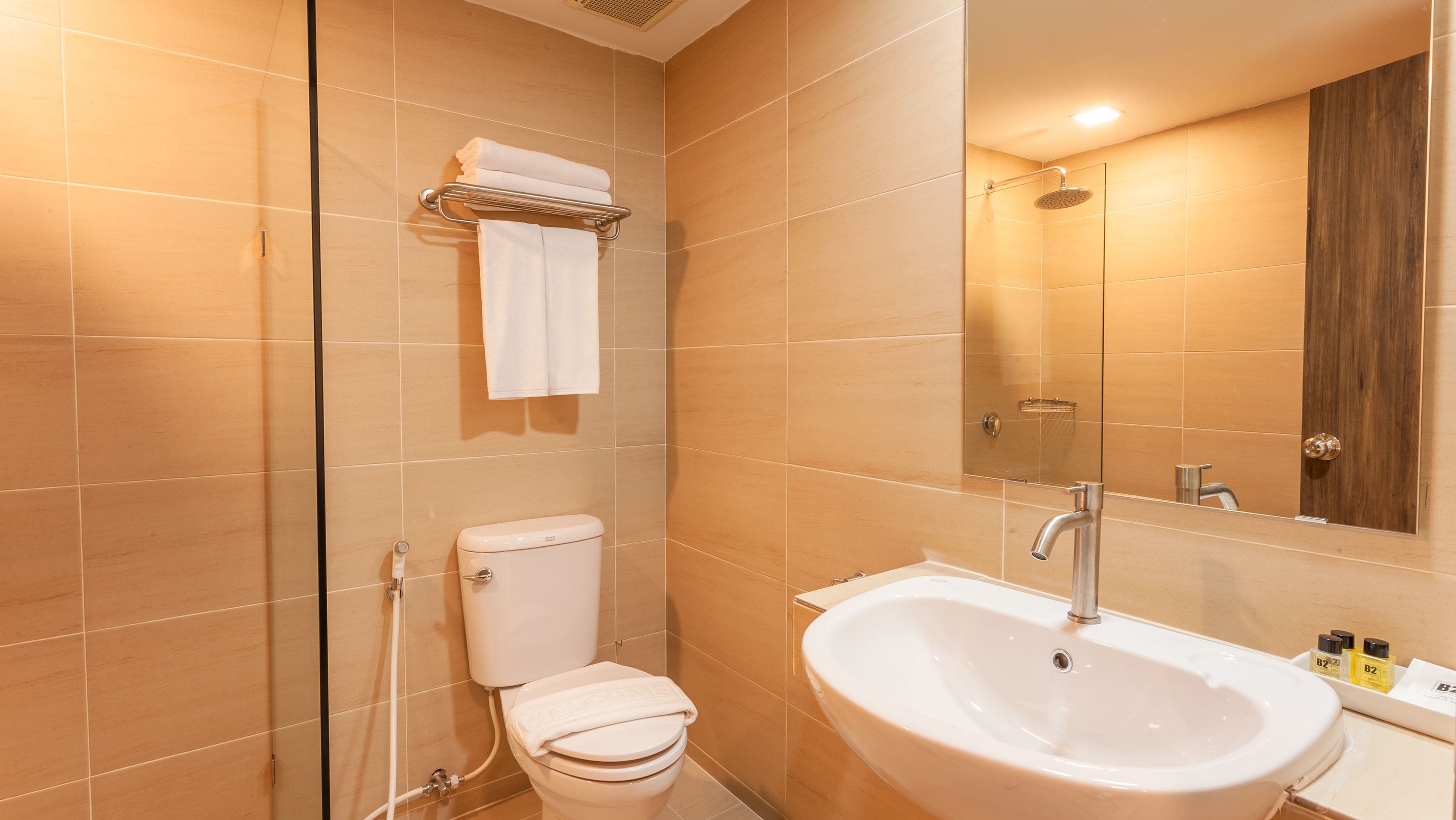 deluxe premier room | bathroom | shower, rainfall showerhead, hair dryer, towels
