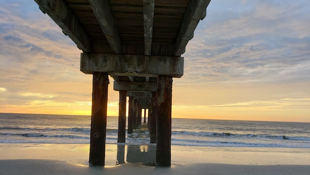 A pier structure with multiple pillars extending into the water. - The Place to Be !! Walk 2 Beach, Restaurants, Activities (St. Augustine)