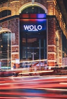 A building with a prominent "WOLO" sign, indicating a hotel or similar establishment.