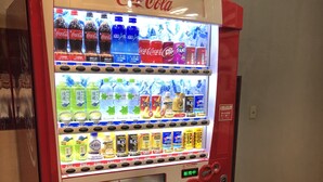 A Coca-Cola vending machine with multiple beverage options and a promotional display. - Hotel Tsuchiura Kandatsu Hills (Tsuchiura)