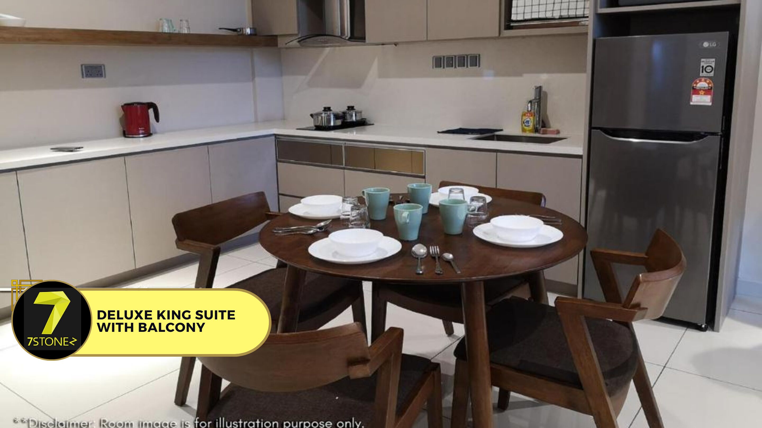 Una cocina moderna con una mesa de comedor para cuatro personas, un refrigerador y una tetera roja sobre la encimera.