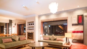 A modern living room with a sofa set, a coffee table, and a fireplace. - Yuuki Toride Chalet (Kutchan)