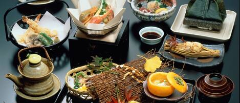 A variety of traditional Japanese dishes arranged on a table, including sushi, sashimi, and other delicacies.