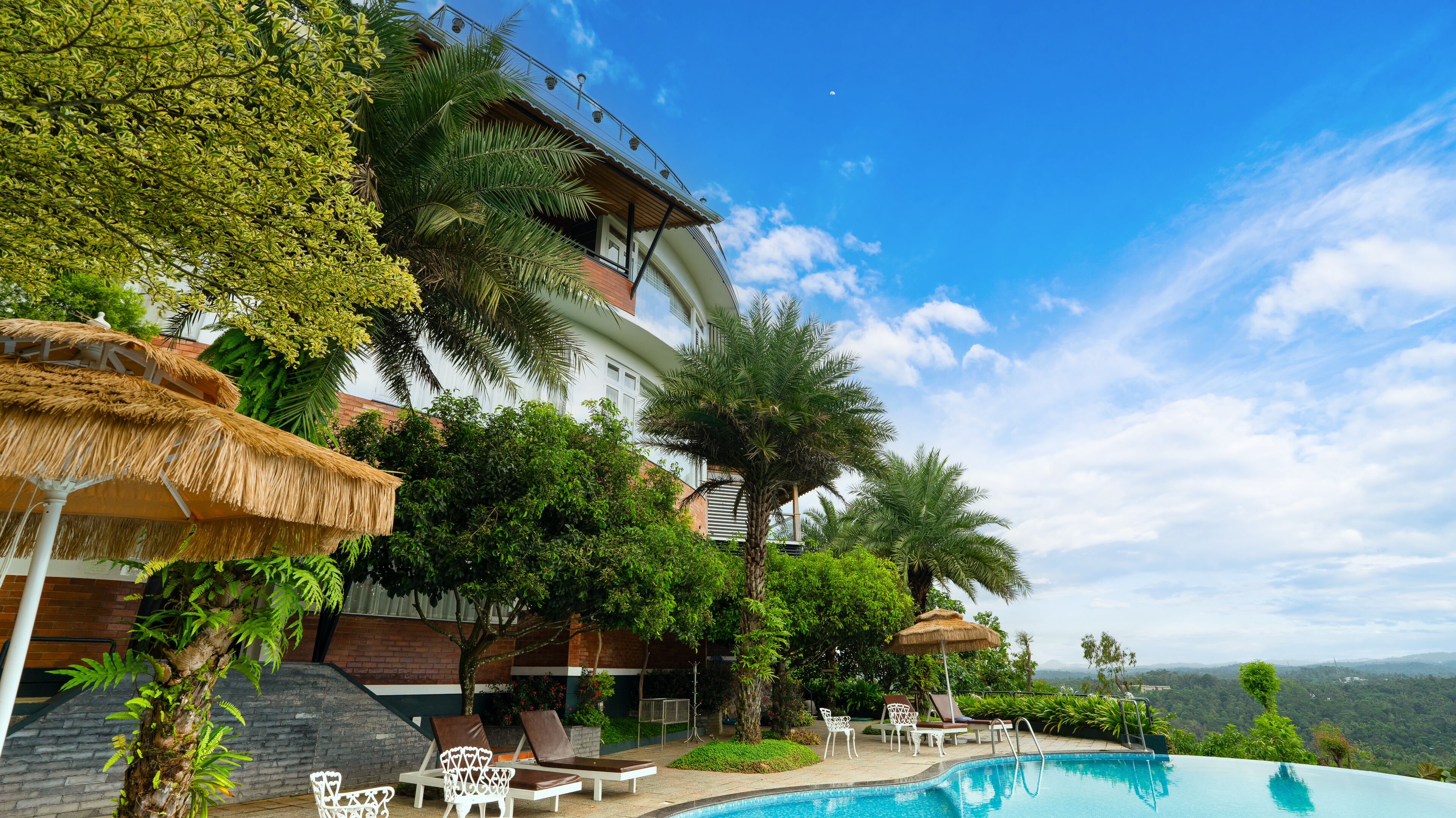 Outdoor pool, an infinity pool, open 8:00 AM to 8:00 PM, pool umbrellas