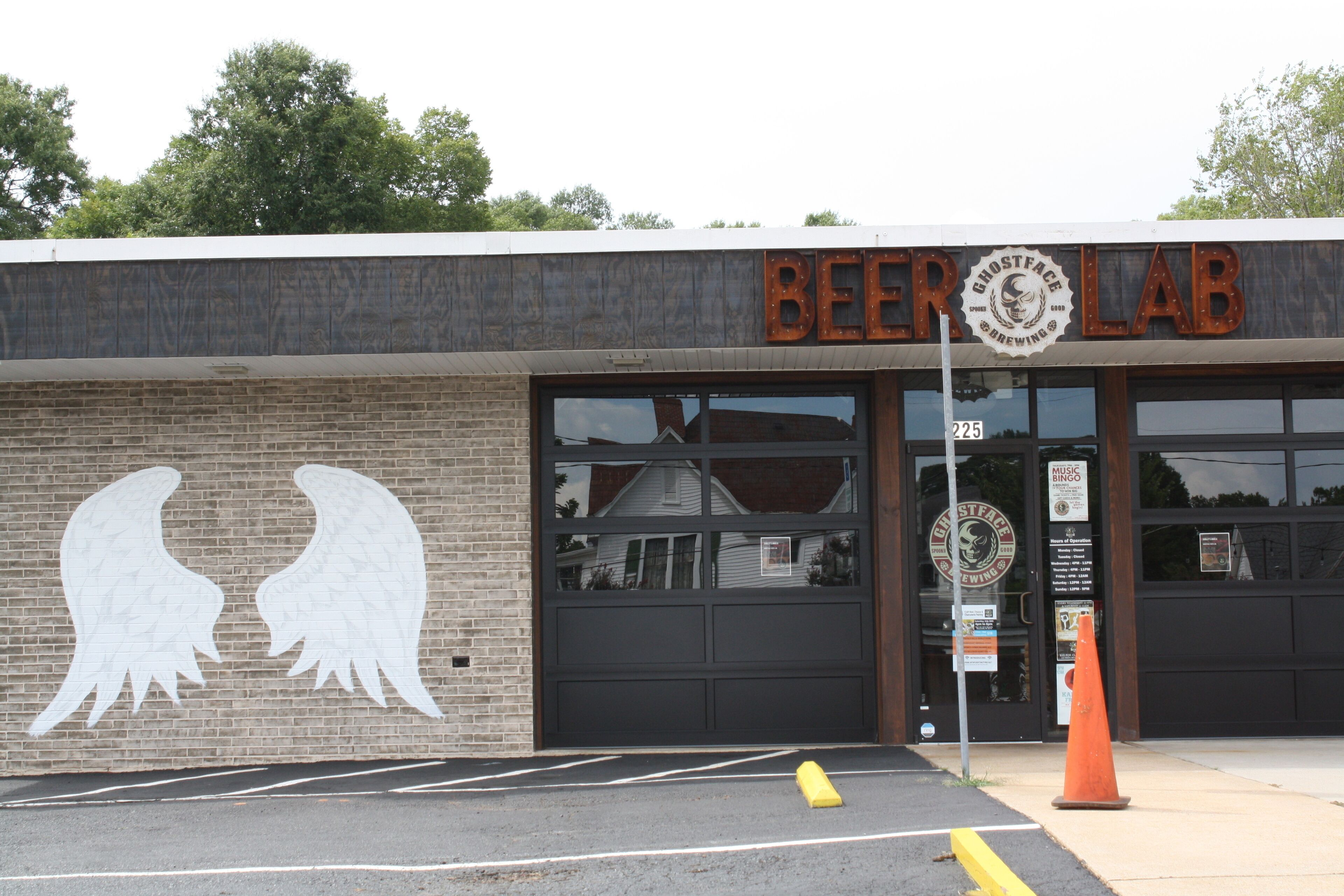 A building with a sign reading "BEER LAB" and a large window.
