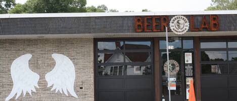 A building with a sign reading "BEER LAB" and a large window.