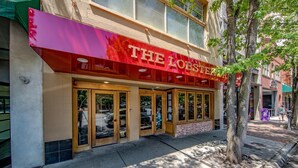 A building with a prominent red awning labeled "THE LOBSTER". - Gallery at 35 Patton (Asheville)