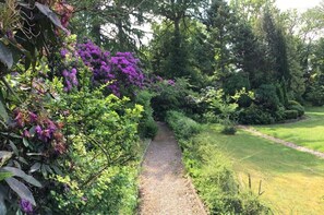 Stroll through the beautifully maintained garden, surrounded by vibrant flowers and lush greenery.
