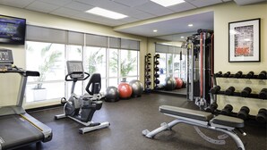 A gym with treadmills, elliptical machines, a squat rack, and various weights. - TownePlace Suites by Marriott El Paso North (El Paso)