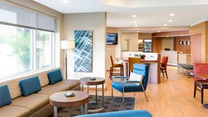 A hotel lobby with a seating area, a bar, and a reception desk. - TownePlace Suites by Marriott El Paso North (El Paso)