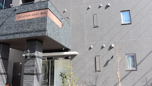 A modern building with a sign reading "VACATION RENT". - Vacation Rent Kanayama (Nagoya)