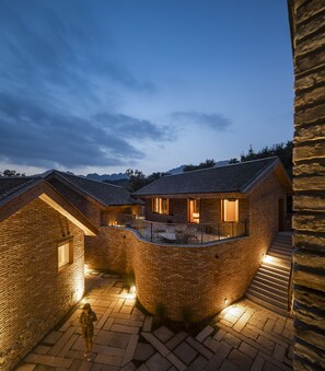 A brick house with a balcony and a staircase leading to the upper floor. - Sansa Village (Huairou)