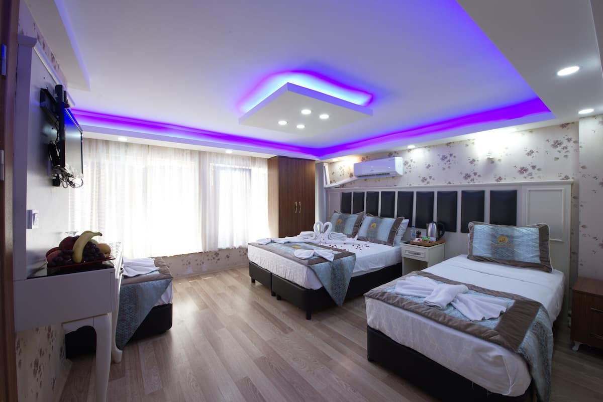 Standard Quadruple Room, Multiple Beds, City View | Minibar, in-room safe, desk, laptop workspace