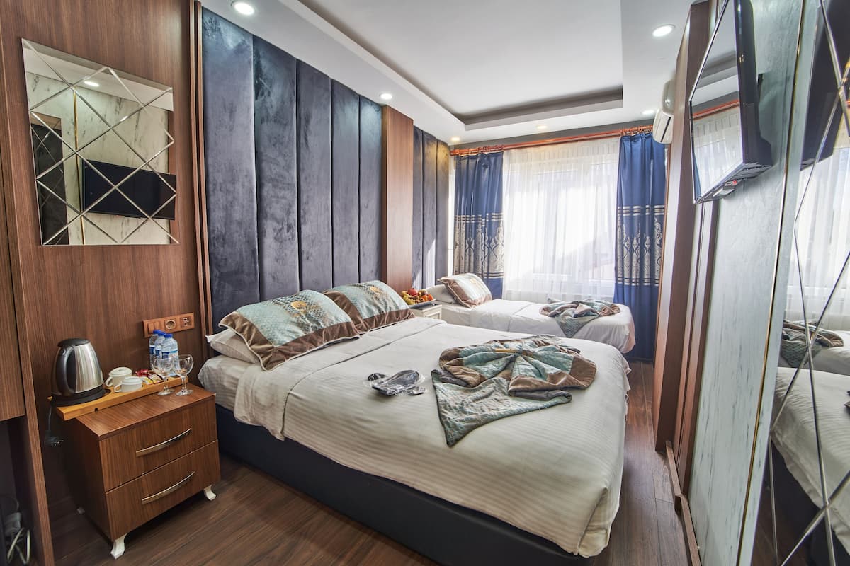 Standard Triple Room | Minibar, in-room safe, desk, laptop workspace