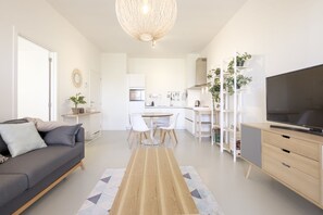 Deluxe Apartment | Living area | 100-cm flat-screen TV with digital channels, TV